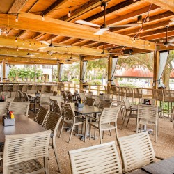 covered patio seating with waterfront views at Top Dawg Tavern